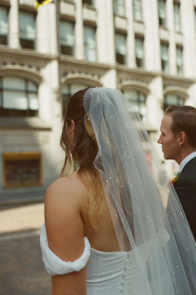 Detail film photo of a brides pearl dusted veil