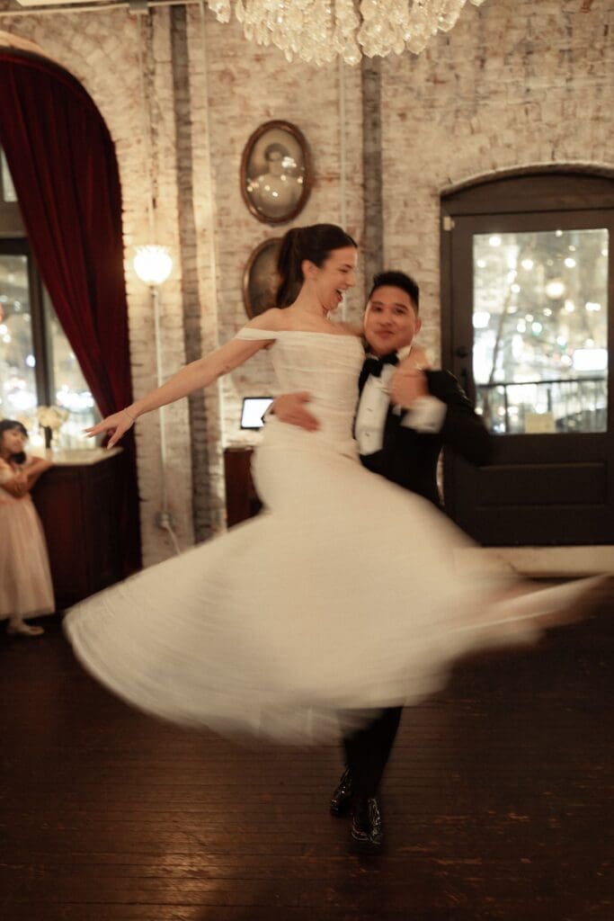 Bride's gown sweeping in motion during the couple's first dance at a Philadelphia wedding