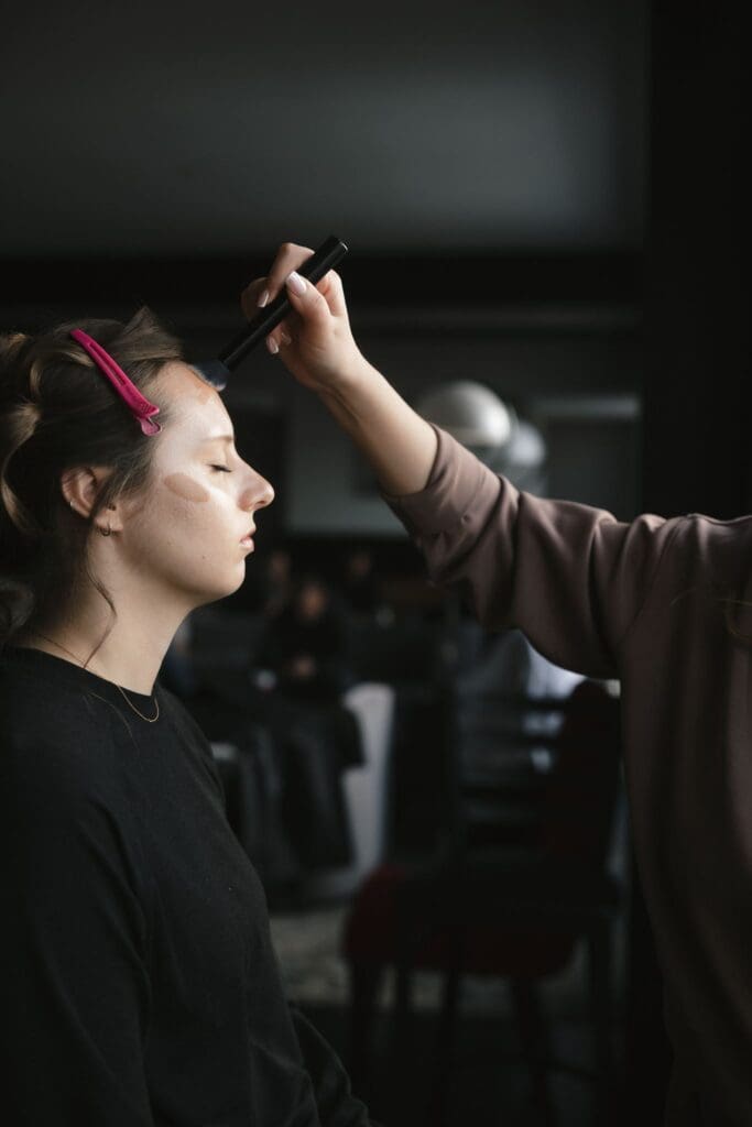 Makeup artist applying foundation to a bridesmaid during getting ready