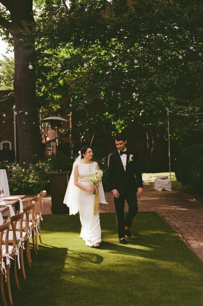 Bride and groom take a tour through their backyard wedding setup at the Powel House in Philadelphia
